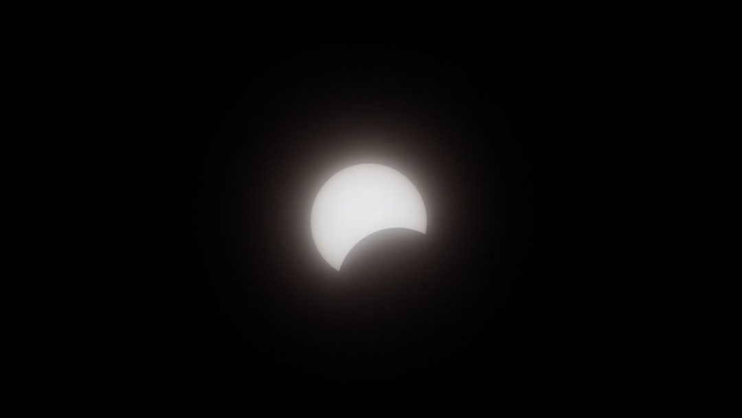 a partial solar eclipse seen through a dark sky