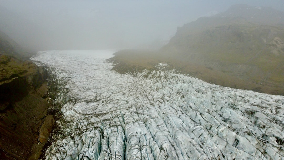 an aerial view of a glacier on a foggy day