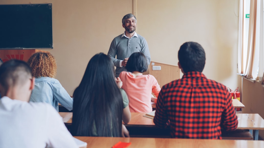 Teacher lecturing students in a classroom setting.