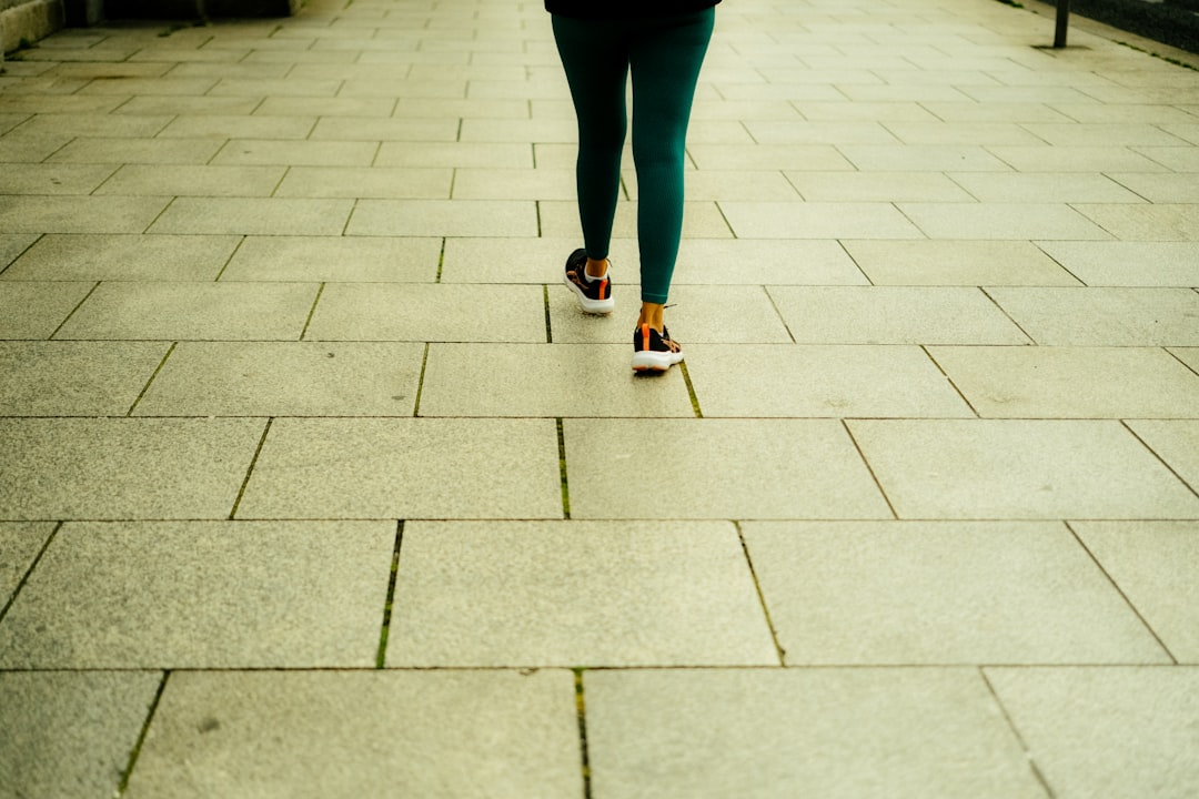 Person walking on a tiled path