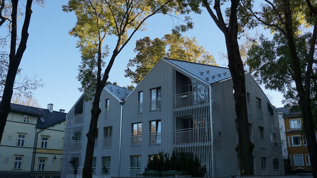 Modern buildings framed by tall trees