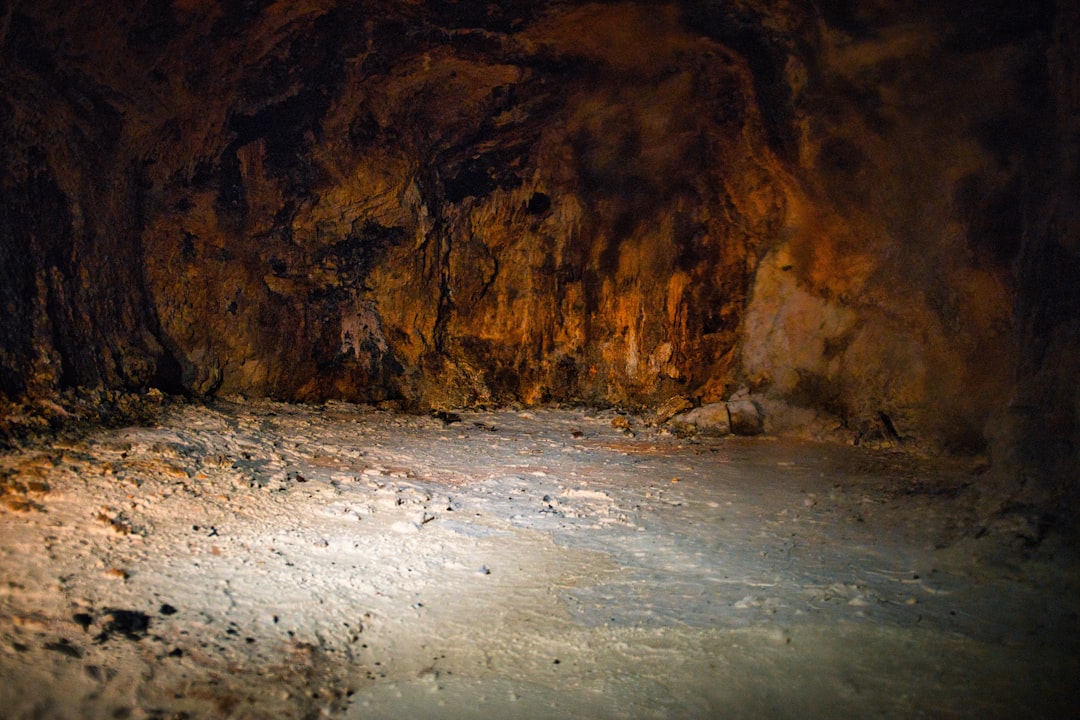 Rough cave interior with textured walls and floor.
