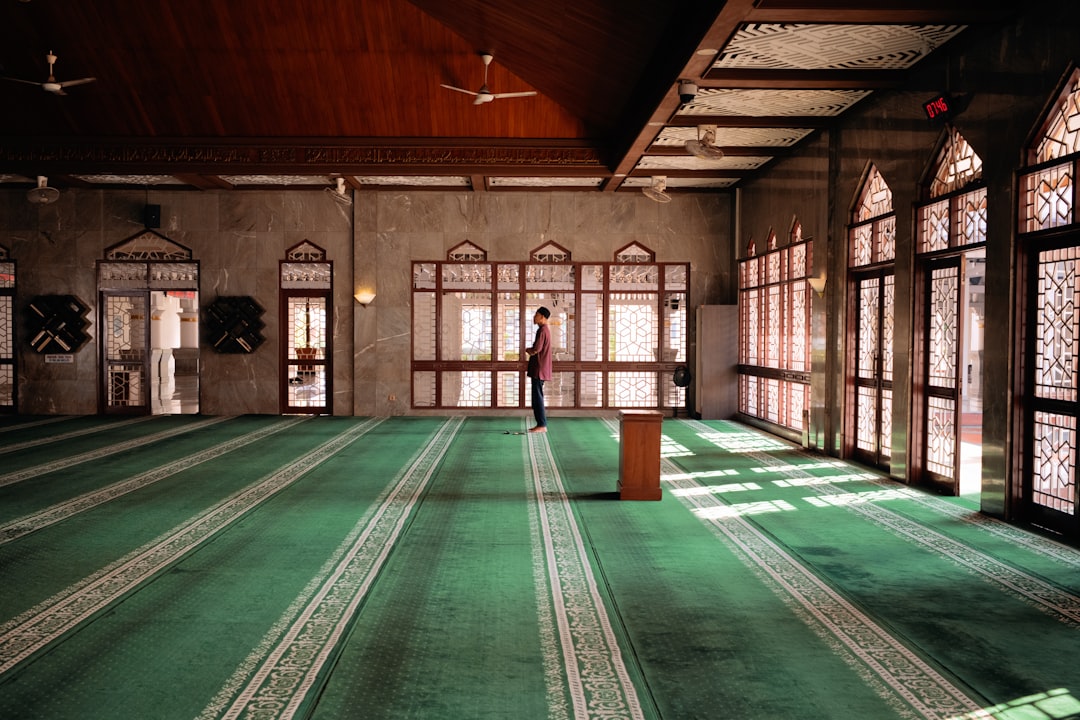 A person stands in a mosque.